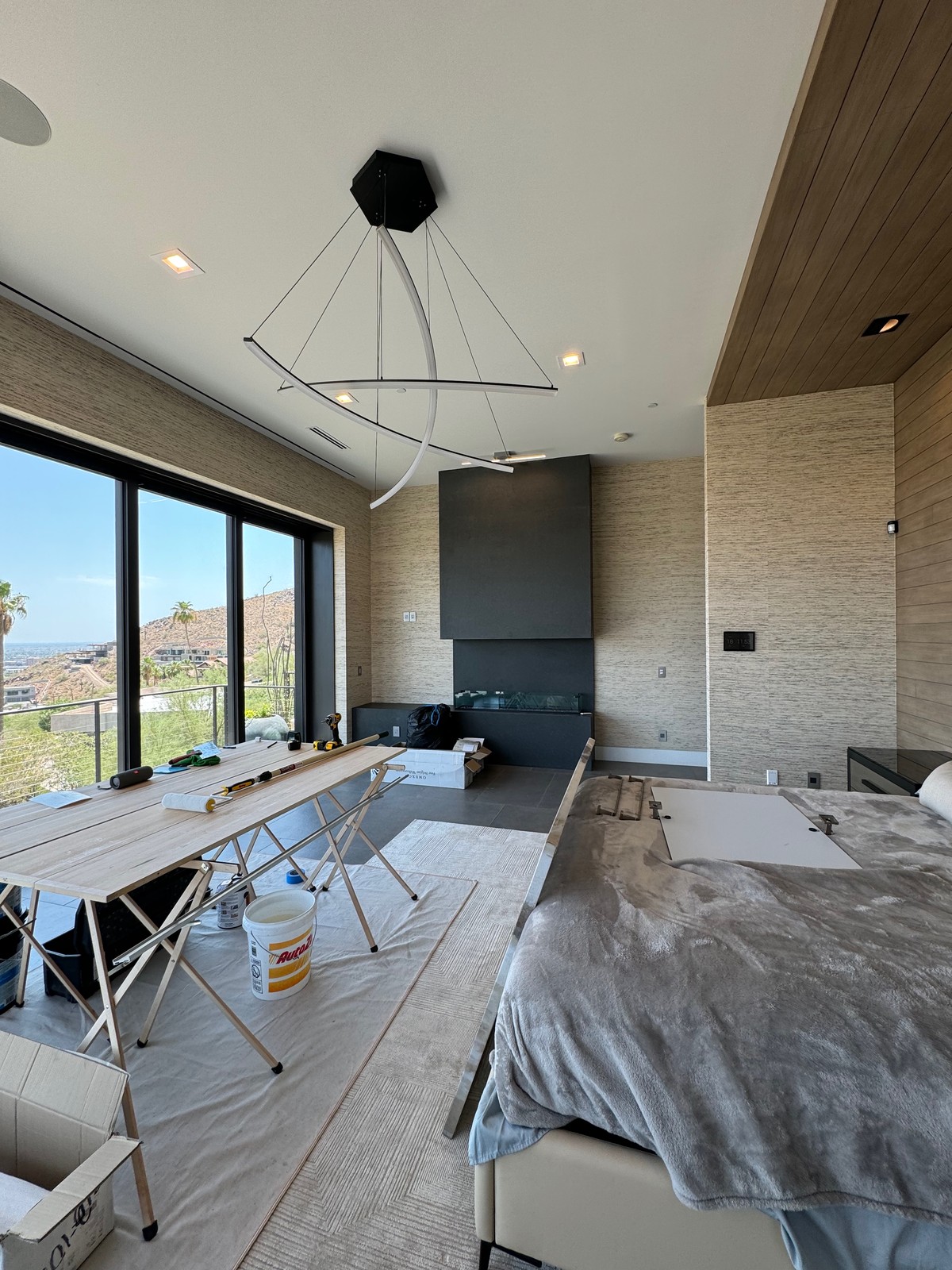 Fireplace focal wall with wool wallcovering and professionally wrapped window reveals