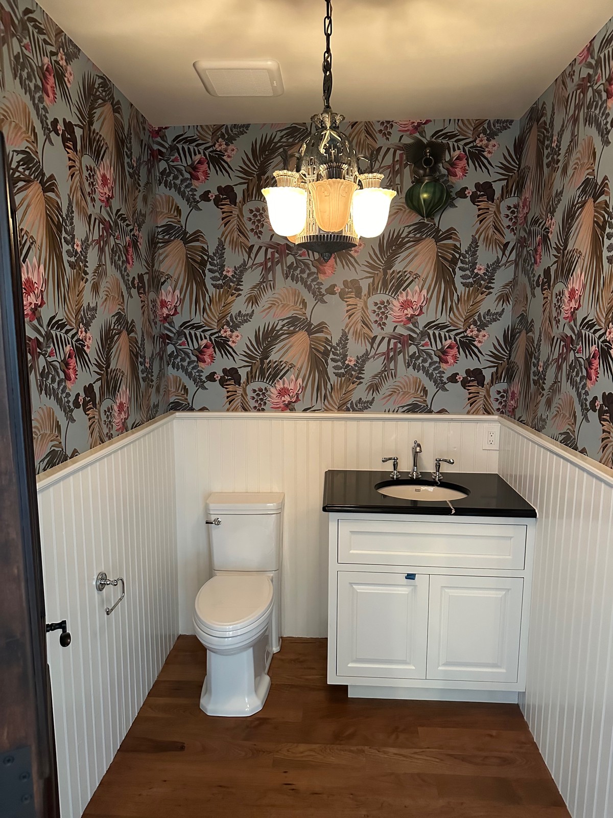 Milton and King wallpaper professionally installed above bathroom wainscoting