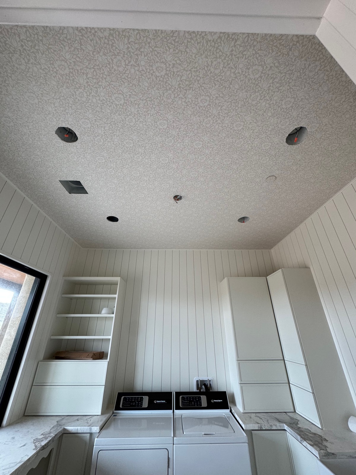 Floral wallcovering professionally installed on bedroom ceiling
