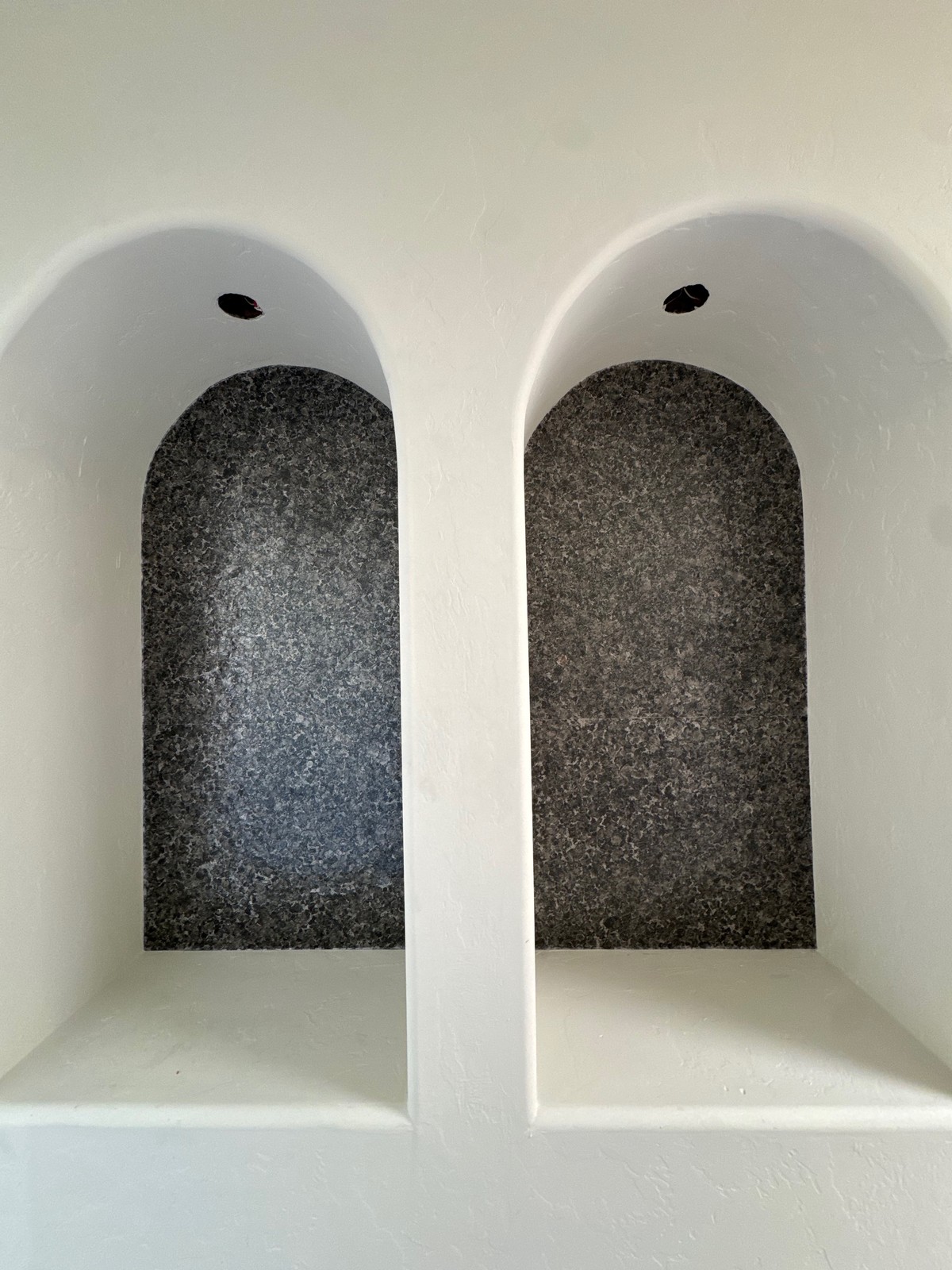 Completed Vahallan crystalline wallcovering installation in arched cubbies